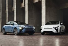2026 Lexus ES 350h Brings Sixth-Gen Hybrid System, Drops Gas-Only Option Blue and white 2026 Lexus ES 350h sedans parked front-facing in concrete garage with headlights on, showcasing hybrid sedan…