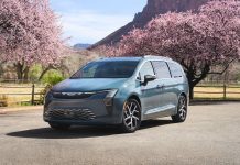 2027 Chrysler Pacifica Ships With Price Cuts Up to $2,060, Safety Sphere Now $395 2027 Chrysler Pacifica minivan parked on rural road surrounded by blooming pink trees and mountains in background