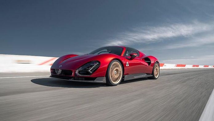 Bright red Alfa Romeo 33 Stradale sports car driving on a racing circuit with white curbing and blue sky overhead.