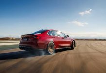 BMW M3 CS Handschalter: Manual, RWD Sendoff Starts at $107,100 Red 2027 BMW M3 CS Handschalter accelerating on open track, side profile view with motion blur emphasizing performance capab…