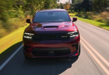 Dodge Durango Hellcat Red Fury Edition Lands in Mexico at $2.17 Million Pesos, 55 Units Only Red Dodge Durango Hellcat driving on a tree-lined highway, front view with motion blur showing performance capability.