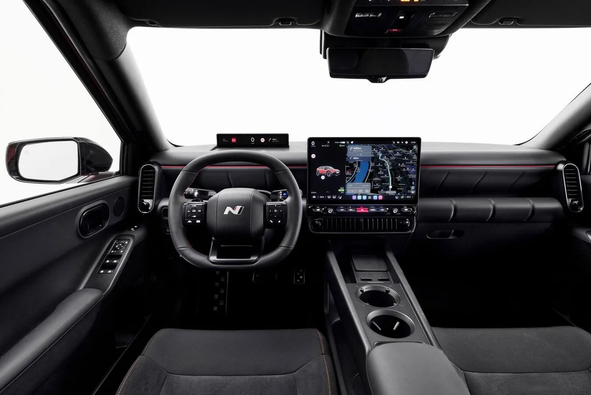 Hyundai N-branded performance vehicle interior dashboard showcasing dual digital displays with Pleos Connect infotainment sy…