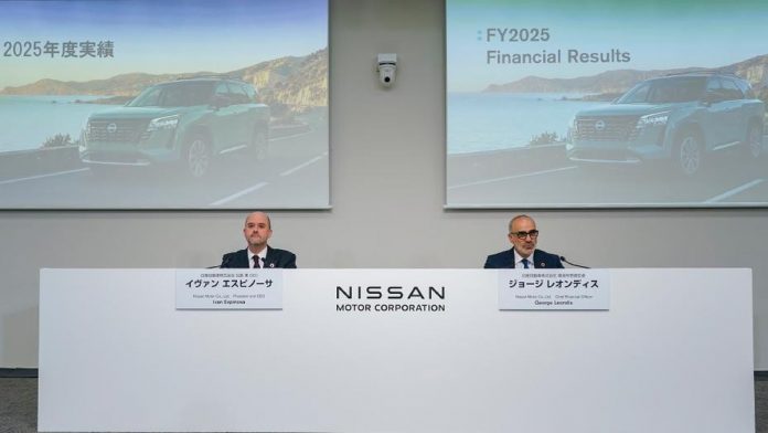 Nissan executives present FY2025 financial results at press conference with Nissan Motor Corporation branding and coastal SU…