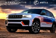 Stellantis Bets on Wayve AI for 2028 Hands-Free Urban Driving Jeep Grand Cherokee 5 concept vehicle with Stellantis and Wayve branding on desert terrain at sunset, showcasing autonomous…