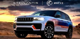 Stellantis Bets on Wayve AI for 2028 Hands-Free Urban Driving Jeep Grand Cherokee 5 concept vehicle with Stellantis and Wayve branding on desert terrain at sunset, showcasing autonomous…